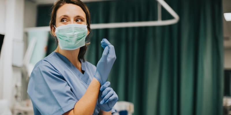 nurse putting on gloves